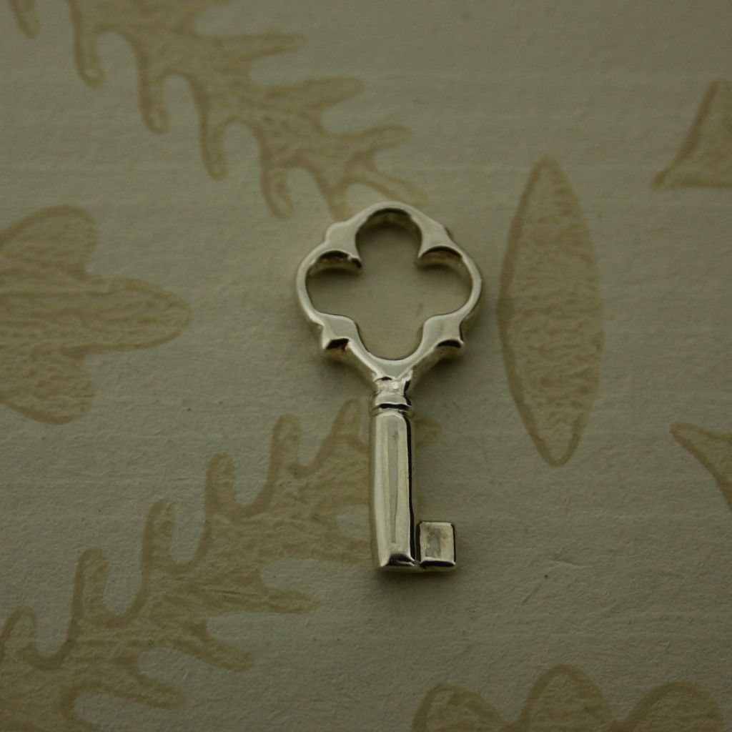 large silver key charm