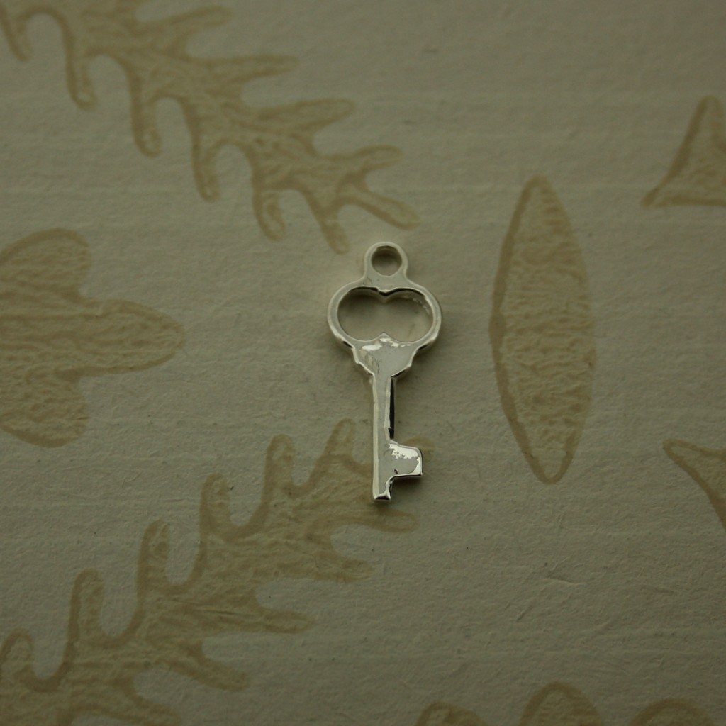 small silver key charm