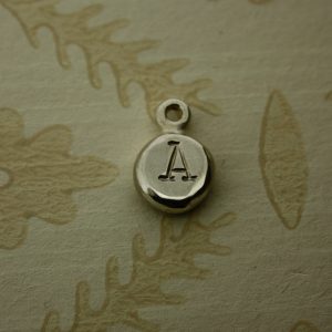 Round silver nugget hand stamped with an initial letter