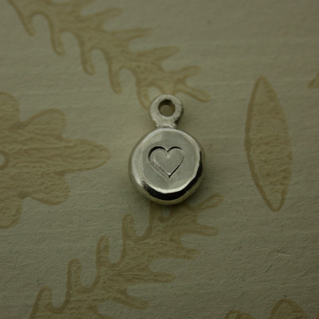 Round silver pebble hand stamped with heart symbol