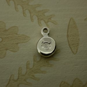 silver pebble hand stamped with skull and crossbones symbol