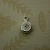 silver pebble charm hand stamped with a star shape
