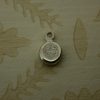 silver pebble charm hand stamped with a tiara symbol