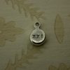 silver pebble charm hand stamped with 21 in roman numerals
