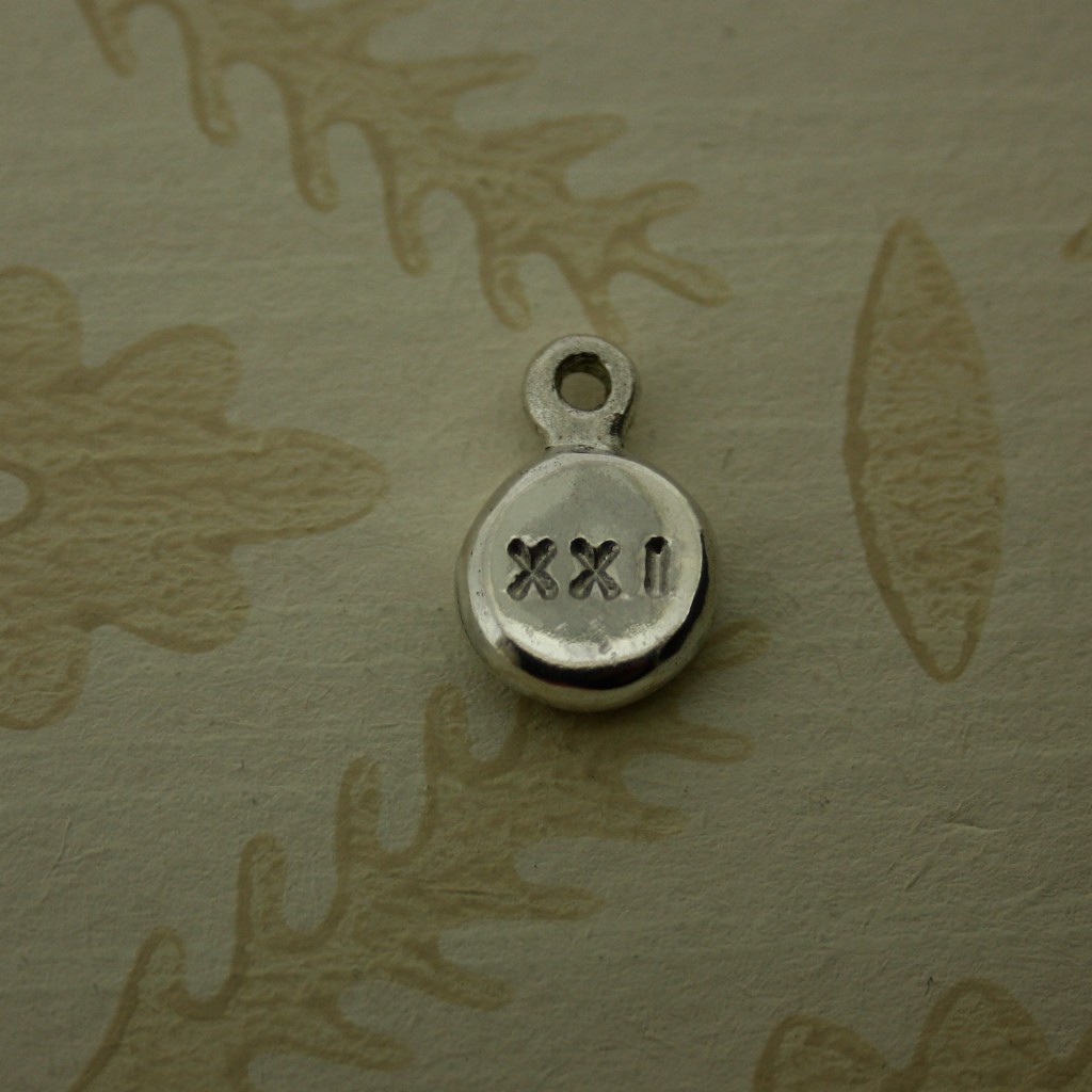 silver pebble charm hand stamped with 21 in roman numerals