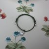 Silver ladybird charm on a cord friendship bracelet
