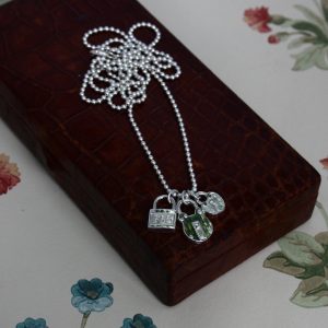 three padlock charms on a long ball chain