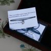 Silver teapot charm on a a length of waxed cotton cord with a quote card