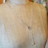 Silver paperclip chain with a ring and a pyramidal heart