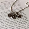 Silver necklace comprising an 18" chain with three pendants stamped with a heart and kisses