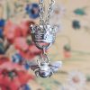 Bumblebee charm hanging under a jubilee crown from a long chain necklace